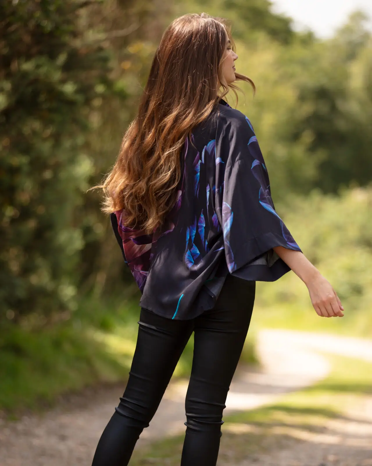 The lightweight short kimono jacket comes in a beautiful floral Jewel Hydrangea print. From the wearable art clothing label, From My Mother’s Garden, the lightweight short kimono can be worn both casually as a smart little coverup. It is made from a draping, silky smooth viscose fabric and has a Hydrangeas print in deep and rich tones. The print is sophisticated with lots of colours that can work beautifully alongside it. The kimono has a stitching detail down the front opening and wide 3/4 length sleeves. Being slightly longer over the hips than at the front, this short kimono jacket creates a very flattering silhouette. Making it exceptionally comfortable to wear whilst ensuring you look fabulously stylish. Comfort and style combined, what more could you want? Pair this lightweight short kimono with a camisole top or polo neck jumper for warmth, and team it up with straight-legged trousers/jeans. For something a little smarter, wear it over a simple block-coloured dress and add a set of heels. It also looks great either knotted at the front or tucked into jeans for a more boho chic style. And you can turn it into a top by wear it back to front and knotting it at the back, either wearing a vest top under it or not! From My Mother’s Garden uses environmentally responsible fabrics and techniques wherever possible. All the new styles are created using sublimation printing which minimises fabric wastage. The first collection includes styles made of Viscose which is a sustainable fabric. Lightweight short kimono Exclusive print Pink, green and white No fastenings Wide 3/4 length sleeves One Size Length: 65cm 100% Viscose 30c cold water Machine Wash Do not soak Sizing Guide: The kimonos fit UK 8 – 18 depending on bust size. They measure approx 65cm across the back under the sleeves