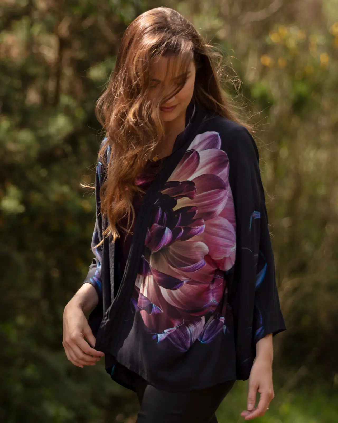 The lightweight short kimono jacket comes in a beautiful floral Jewel Hydrangea print. From the wearable art clothing label, From My Mother’s Garden, the lightweight short kimono can be worn both casually as a smart little coverup. It is made from a draping, silky smooth viscose fabric and has a Hydrangeas print in deep and rich tones. The print is sophisticated with lots of colours that can work beautifully alongside it. The kimono has a stitching detail down the front opening and wide 3/4 length sleeves. Being slightly longer over the hips than at the front, this short kimono jacket creates a very flattering silhouette. Making it exceptionally comfortable to wear whilst ensuring you look fabulously stylish. Comfort and style combined, what more could you want? Pair this lightweight short kimono with a camisole top or polo neck jumper for warmth, and team it up with straight-legged trousers/jeans. For something a little smarter, wear it over a simple block-coloured dress and add a set of heels. It also looks great either knotted at the front or tucked into jeans for a more boho chic style. And you can turn it into a top by wear it back to front and knotting it at the back, either wearing a vest top under it or not! From My Mother’s Garden uses environmentally responsible fabrics and techniques wherever possible. All the new styles are created using sublimation printing which minimises fabric wastage. The first collection includes styles made of Viscose which is a sustainable fabric. Lightweight short kimono Exclusive print Pink, green and white No fastenings Wide 3/4 length sleeves One Size Length: 65cm 100% Viscose 30c cold water Machine Wash Do not soak Sizing Guide: The kimonos fit UK 8 – 18 depending on bust size. They measure approx 65cm across the back under the sleeves