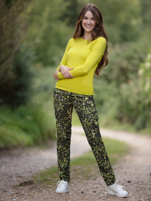 From My Mother's Garden leaf camouflage print trousers in khaki green made of a stretch cotton. The trousers are mid-rise