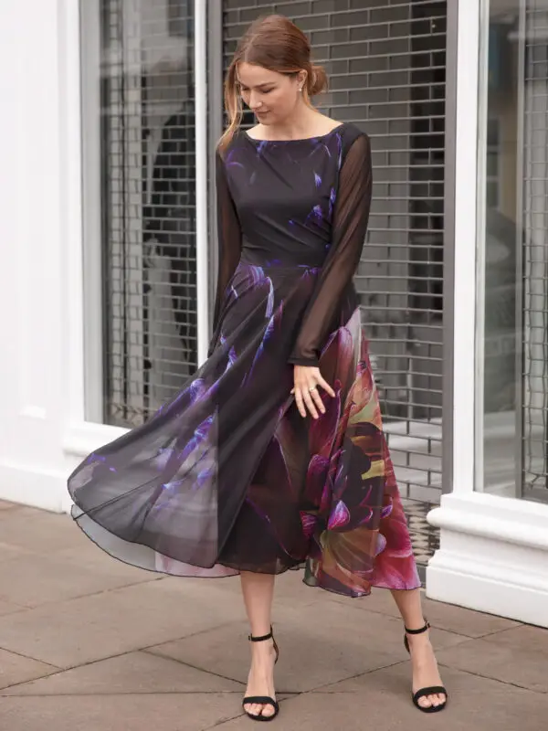 Deep As Dahlia Tulle Dress is a pretty and elegant party dress ideal for cocktail parties or a special occasion. The midi dress is black with a pretty floral print of dahlias. The Fit and Flare dress has semi sheer sleeves and a boat neckline. Perfect swish dress for dancing!