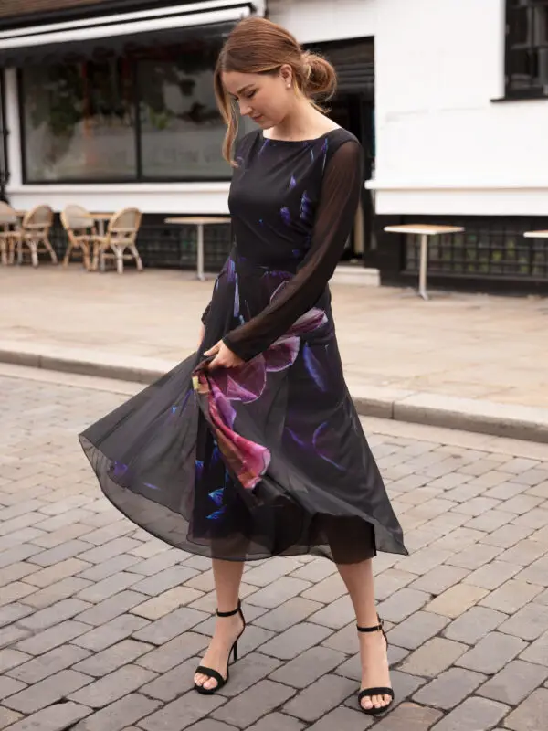 Deep As Dahlia Tulle Dress is a pretty and elegant party dress ideal for cocktail parties or a special occasion. The midi dress is black with a pretty floral print of dahlias. The Fit and Flare dress has semi sheer sleeves and a boat neckline. Perfect swish dress for dancing!