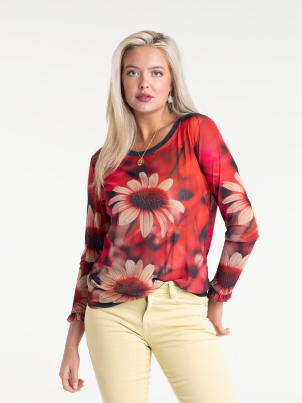 Dahlia Fire Tulle Top by From My Mother's Garden is a striking floral top with a scoop neckline and long sleeves. It has a Dahlia flower print on a red background
