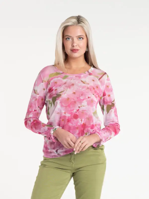 Cherry Blossom Tulle Top by From My Mother's Garden is a pretty, feminine top with a scoop neckline and long sleeves. It has a pink print on a white background