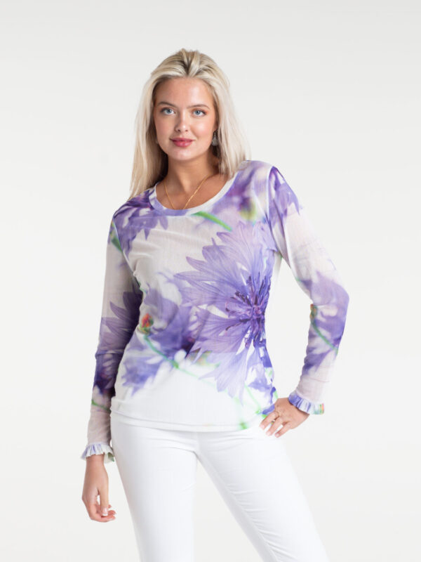 Cornflower Tulle Top by From My Mother's Garden is a pretty, feminine top with a scoop neckline and long sleeves. It has a Cornflower blue flower print on a white background