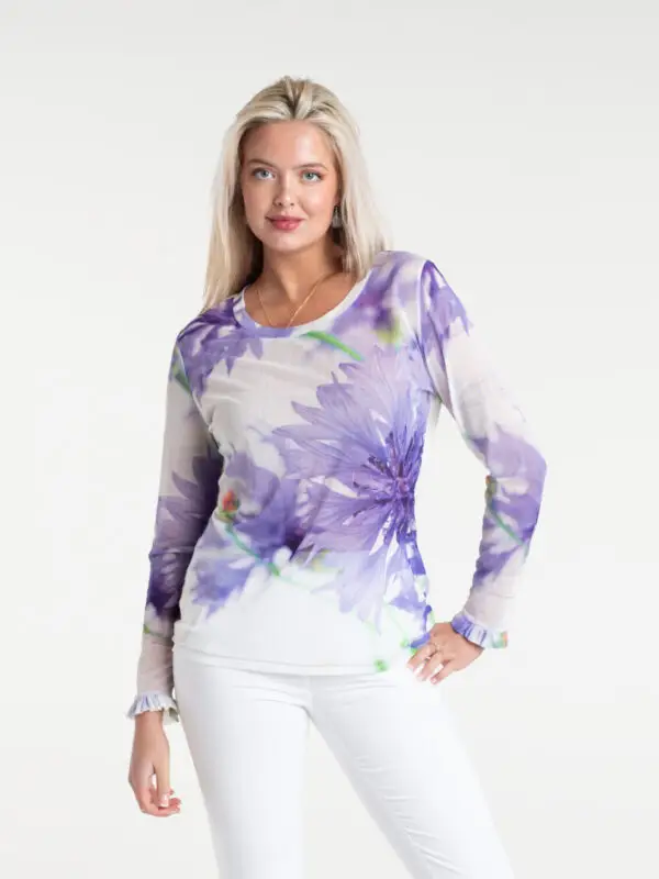 Cornflower Tulle Top by From My Mother's Garden is a pretty, feminine top with a scoop neckline and long sleeves. It has a Cornflower blue flower print on a white background