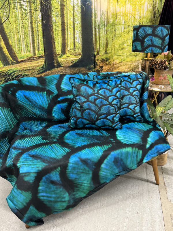From My Mother's Garden Peacock Fleece Throw is a soft blanket with a fleecy back