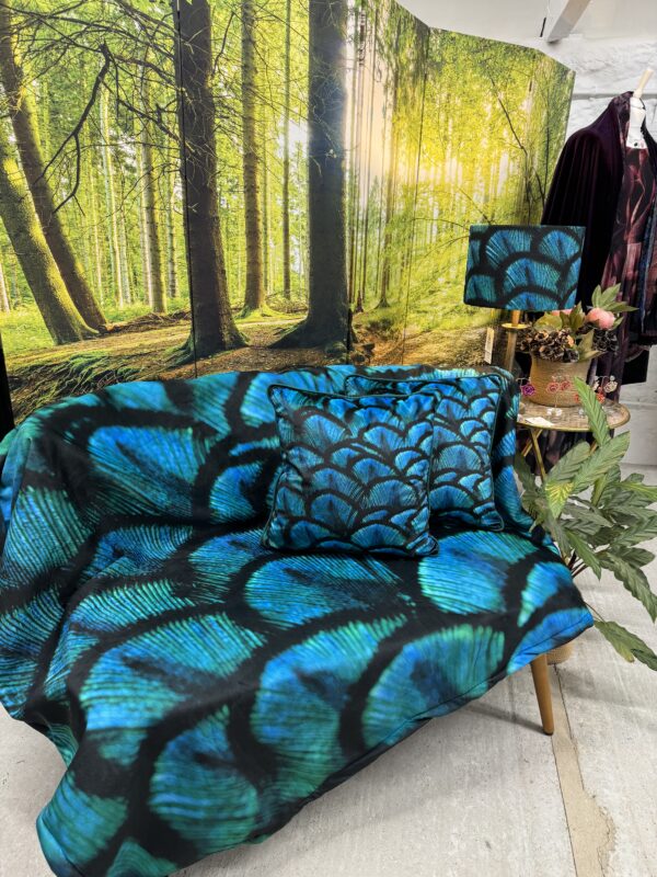 From My Mother's Garden Peacock Fleece Throw is a soft blanket with a fleecy back