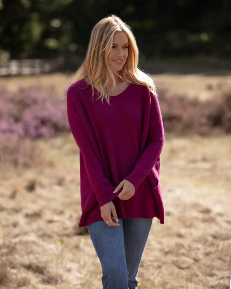 From My Mother's Garden wide fit jumper in magenta. It is a longer jumper and has a round neck and two pockets on the front
