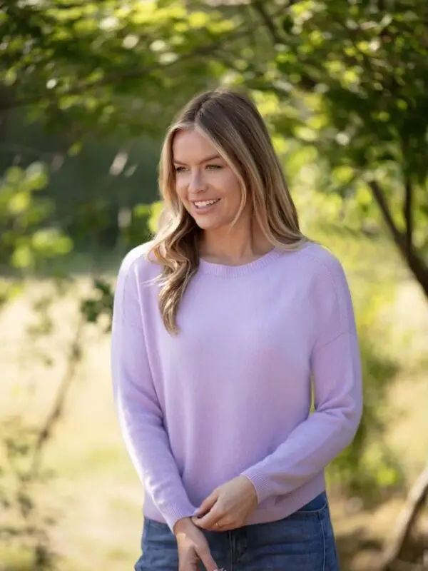Woman wearing a soft lilac cashmere-feel jumper outdoors